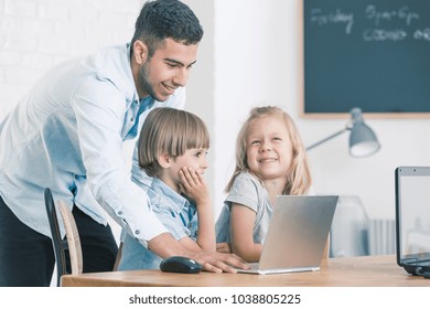 Spanish Teacher With Kids Learning How To Code During IT Classes