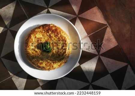 spanish tortilla omelet traditional tapas food on traditional rustic old tiles background in seville