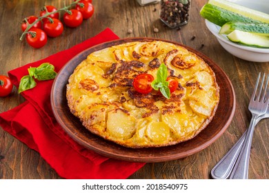 Spanish Tortilla, Traditional Dish With Eggs And Fried Potatoes On A Clay Plate On A Wooden Background. Potato Recipes. Thanksgiving Day