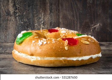 Spanish typical dessert of epiphany "Roscon de Reyes", on wooden background
