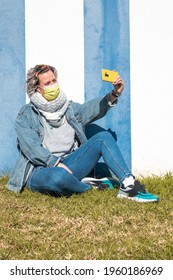 A Spanish Woman Wearing A Face Mask While Taking A Selfie