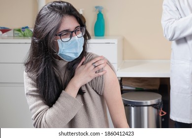 Spanish Woman Wearing Surgical Mask And Glasses Getting Ready To Be Vaccinated.