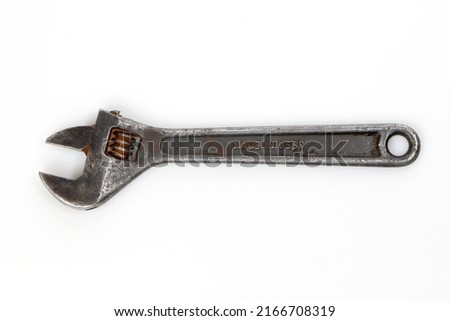 Spanner isolated on white background, iron Russian monkey wrench made in USSR. Top view of vintage adjustable spanner, rusty screw key. Concept of mechanic tool, old nut wrench, shifting and torque.