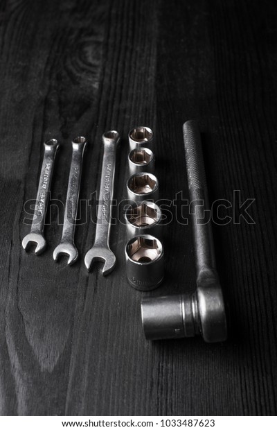 spanners on a black wooden
texture
