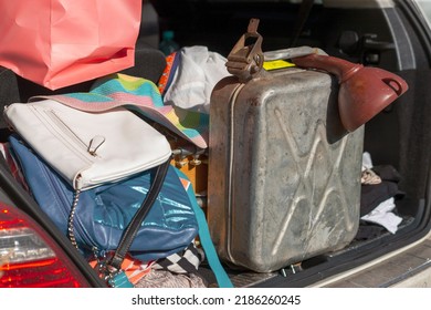 A Spare Jerrycan In A Messy Car Boot Along With Personal Luggage