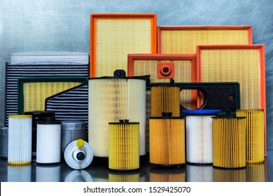 Spare parts for car. Oil filter, air filter, fuel filter, cabin filter close-up on a steel background.