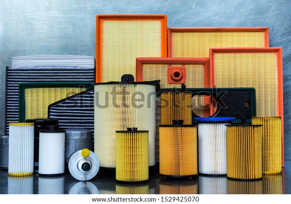 Spare parts for car. Oil\
filter, air filter, fuel filter, cabin filter close-up on a steel\
background.