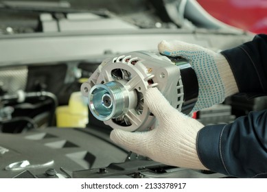 Spare parts. Thermostat for an automobile engine. Close-up. A mechanic inspects a new thermostat when replacing a faulty thermostat. Maintenance and repair in a car service. - Shutterstock ID 2133378917