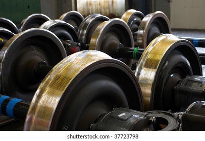 Spare railway wheels on the axle in a repair workshop