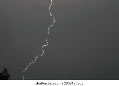 A spark discharge between a cloud and the ground. This natural phenomenon is also called lightning. It occurs when a cloud becomes electrified.