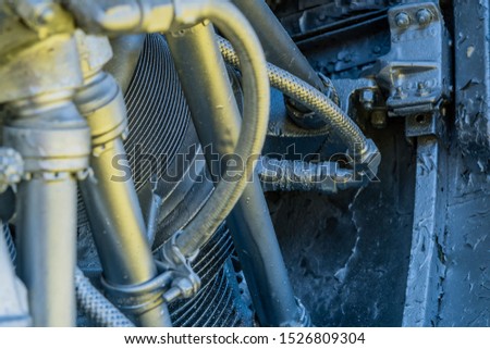 Spark plug in piston of radial engine that has been painted silver.