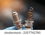 Spark plugs compare, new and old copper spark plugs. Spark plugs with worn electrodes and new one. Selective focus. Electrical ignition parts of gasoline engine. 