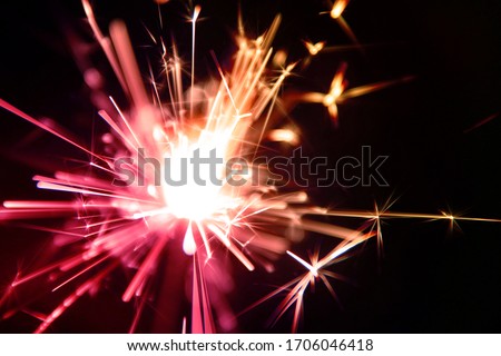 Sparkler is a type of hand held firework that burns slowly while emitting colored flames, sparks, and other effects
