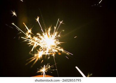 A sparkler is a type of small firework that emits colorful, shimmering lights when ignited, resembling twinkling stars in the night sky. People often play with sparklers during celebrations.