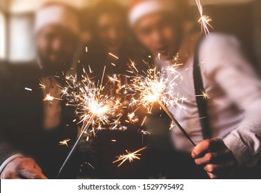 Sparklers In The Foreground. Beautiful Young People At A Corporate Party. New Year Celebration. Club Party With Friends