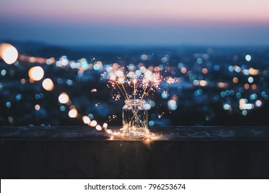 Sparklers in a glass jar that bokeh cities background. - Powered by Shutterstock