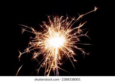 Sparklers on black isolated background. Sparks from a burning sparkler. To insert an image in a blend mode - Shutterstock ID 2388338001