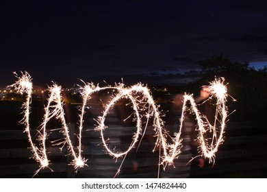 Sparklers Writing Wow Into Night Sky