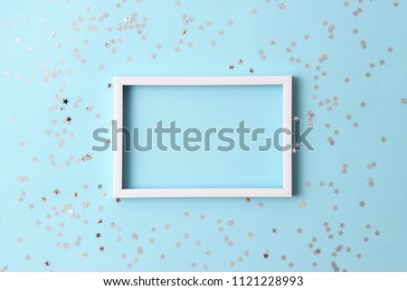 sparkles confetti and frame for inserting text on a colored background top view. Minimalism, design, insta, holiday. flatlay
