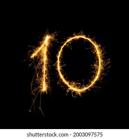 Sparkling burning number 10 isolated on black background. Beautiful Glowing golden overlay object ten number for design holiday greeting card for Birthday,  anniversary