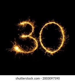 Sparkling burning number 30 isolated on black background. Beautiful Glowing golden overlay object thirty number for design holiday greeting card for Birthday,  anniversary; 