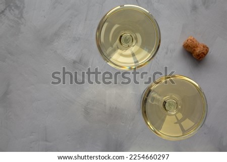 Sparkling Champagne in a Coupe Glass on a gray background, top view. Flat lay, overhead, from above.