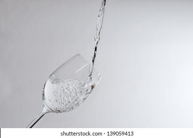 sparkling clear water in the wine glass pouring - Powered by Shutterstock