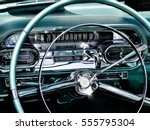 A sparkling closeup of a chrome and teal antique car dashboard with sun reflections at a car show in Mizner Park, Boca Raton FL