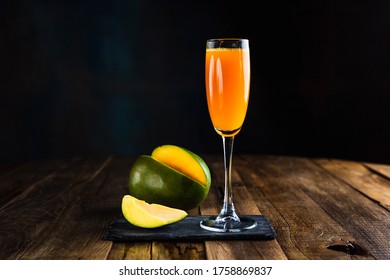 A Sparkling Cocktail With Mango In A Flute Glass