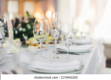Sparkling cyrstal glasses stand on a dinner table