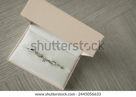 A sparkling diamond bracelet showcased in an open beige box