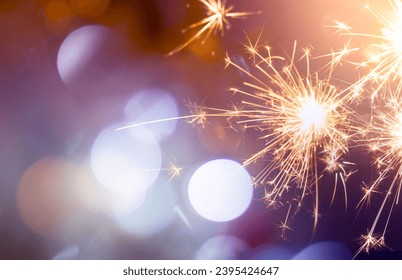 sparkling from fireworks and light bokeh. background for New Year's celebrations, banner design. on the dark blue night sky - Shutterstock ID 2395424647