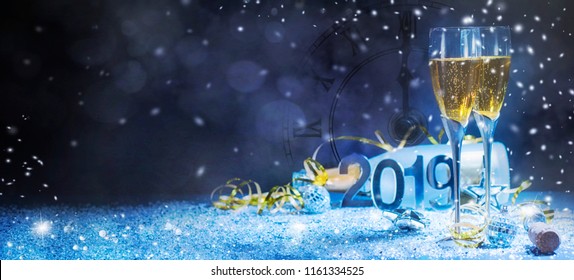 Sparkling New Year Background. Champagne Explosion With Toast Of Flutes