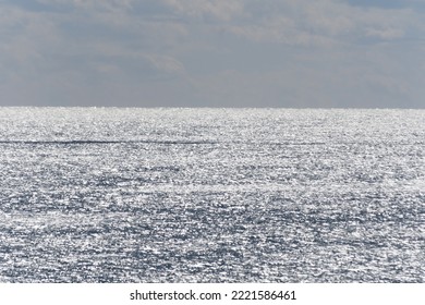 Sparkling Ocean With Low Clouds