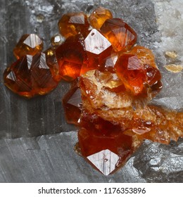 Sparkling orange spessartine garnets on Smoky Quartz crystals