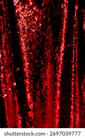 Sparkling red sequin background, featuring a shimmering red texture. Ideal for festive and glamorous designs. Vibrant color glittery design background.