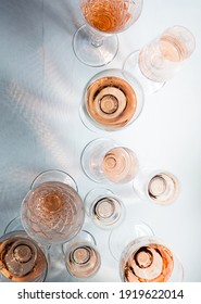 Sparkling Rose Wine In Different Glasses On Grey Background.