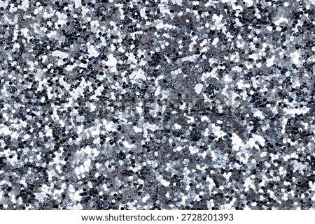 Sparkling silver glitter texture. Glitter background with shimmering silver tones. Perfect for festive designs, party invitations, or glamorous projects. Festive background with copy space.