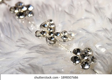 sparkling silver jewelry on white fluffy fur, copy space