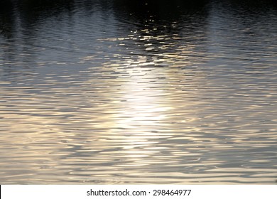 Sparkling water with lights of sunset