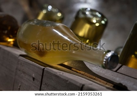 Sparkling white and rose wine production by traditional methods in underground cellars in Vienna, Austria. Sediment in bottle.