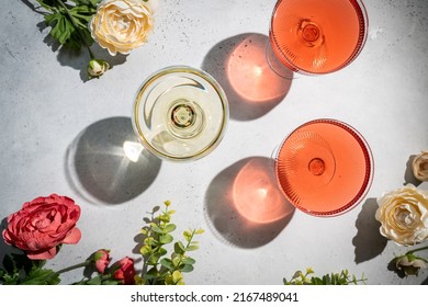 Sparkling wine or champagne glasses on white background with sharp shadows, top view. Modern, stylish color concept