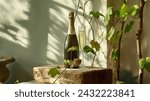 Sparkling wine in a flute with a bottle on a rustic wood surface, graced by vine shadows