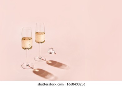 Sparkling Wine Glasses On Colored  Background. Champagne Glasses With Sharp Shadows. Modern, Stylish Color Concept
