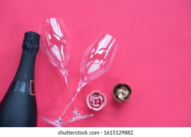 Sparkling wine, Glasses, Tulip rose chocolate on pink background