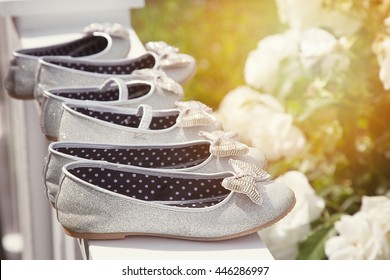 Sparkly Bridesmaid Shoes Lined Up In The Sunlight. 