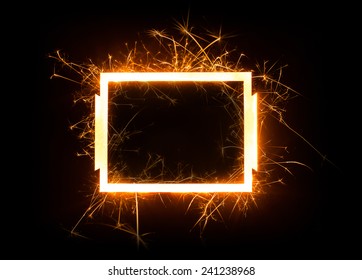 Sparkly glowing empty rectangle frame with copy space on dark background.