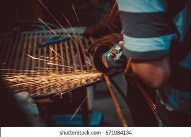 Sparks during cutting of metal angle grinder. Close-up saw sawing a steel. Soft focus. Shallow DOF - Shutterstock ID 671084134