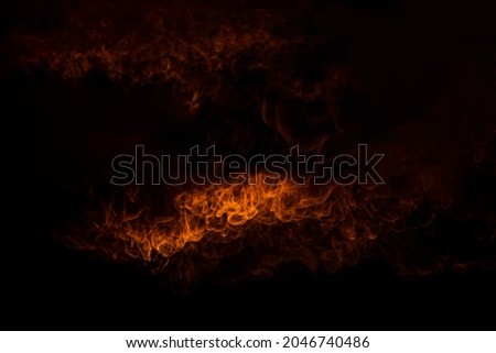Sparks and fire particles,Flying up embers and burning cinder,Smoke,Fire flames on a black background.