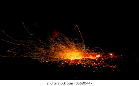 Sparks Fire And The Trajectory Of Falling Embers From The Explosion. The Photo Was Taken At Night On Slow Shutter Speeds